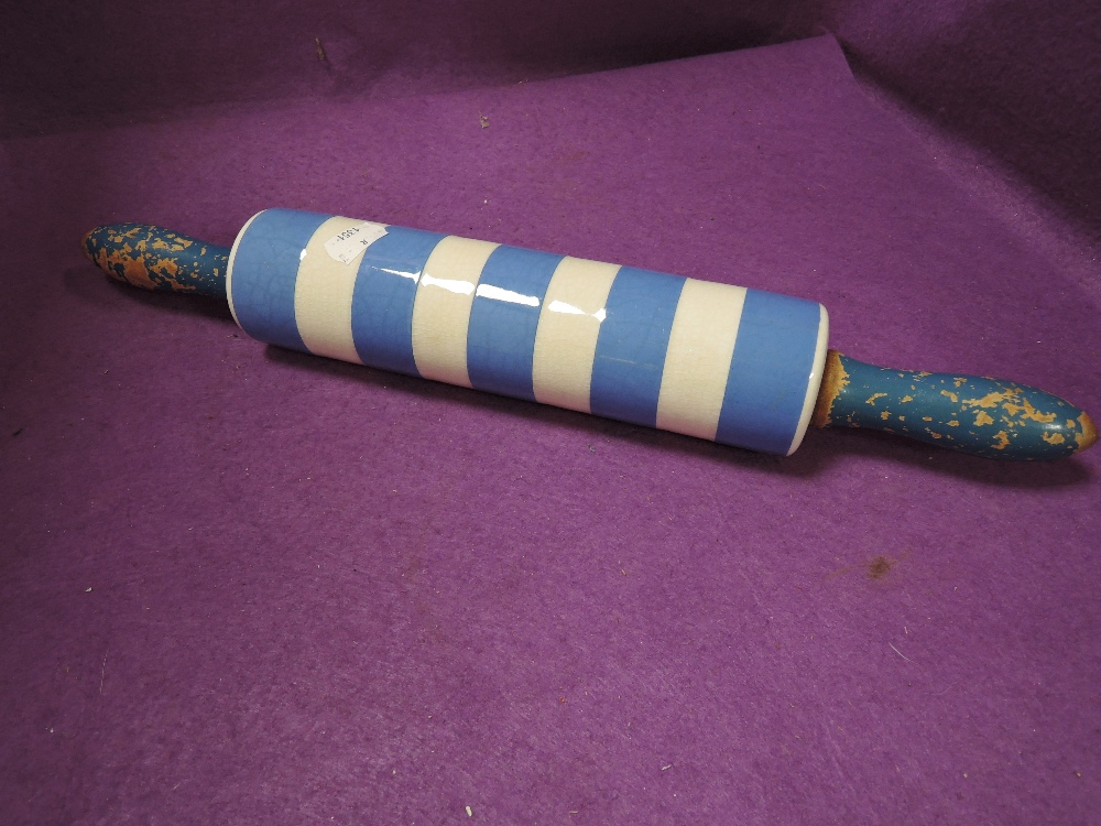 A kitchen rolling pin having a ceramic body by T.G Green on a green stamp