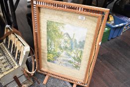 A vintage wooden framed fire screen with a mirror boarder