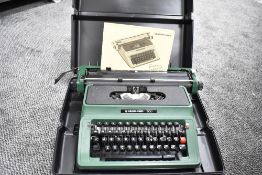 A silver Reed typewriter in case