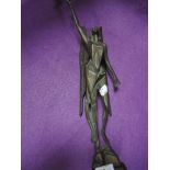 A bronze art deco geometric styled figure of an angel holding chalice atop a rocky outcrop 42cm