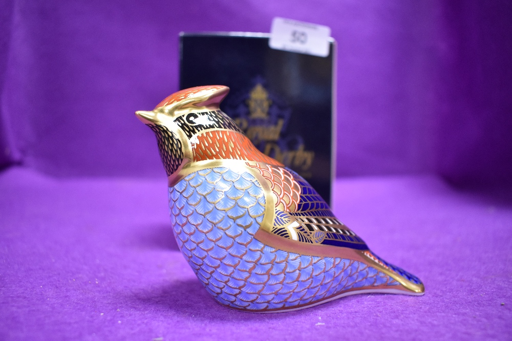 A ceramic Royal Crown Derby paper weight or figure of a wax wing having silver stopper and box