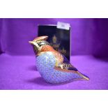 A ceramic Royal Crown Derby paper weight or figure of a wax wing having silver stopper and box