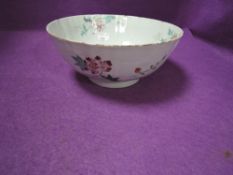 An antique Chinese porcelain punch or slop bowl having hand decorated naturalistic design