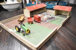 A vintage toy farm with some figures and die cast Dinky
