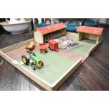 A vintage toy farm with some figures and die cast Dinky