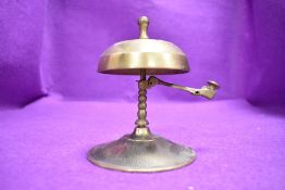 A brass bell having a flip ring mechanism