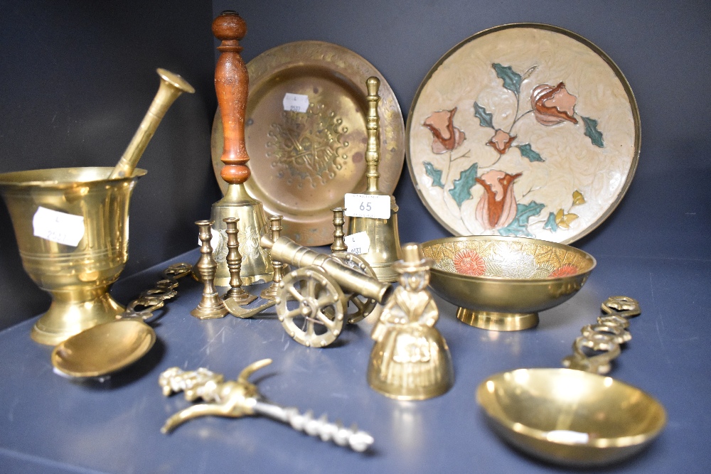 A selection of brass wares including model cannon corkscrew and mortar and pestle