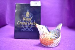 A ceramic Royal Crown Derby paper weight or figure of a Bluebird having gold stopper and box