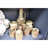 A wine decanter and goblet set by Tremar pottery and two additional mugs