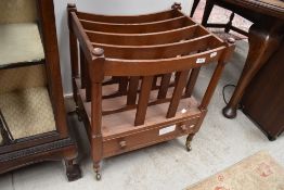 A reproduction mahogany Canterbury style magazine rack having drawer base