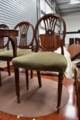 A set of four reproduction dining chairs , nice quality with motif to back, over stuffed seats