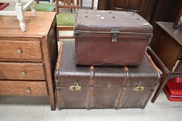 Two vintage travel trunks, including cloth and wood bound and tin bearing shipping labels