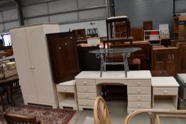 A selection of modern laminated white bed room furniture including bedside cabinets dressing table