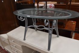 A modern glass top coffee table having metal frame