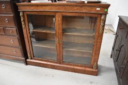 A Victorian Empire style cabinet having satinwood inlay and ormolu decoration