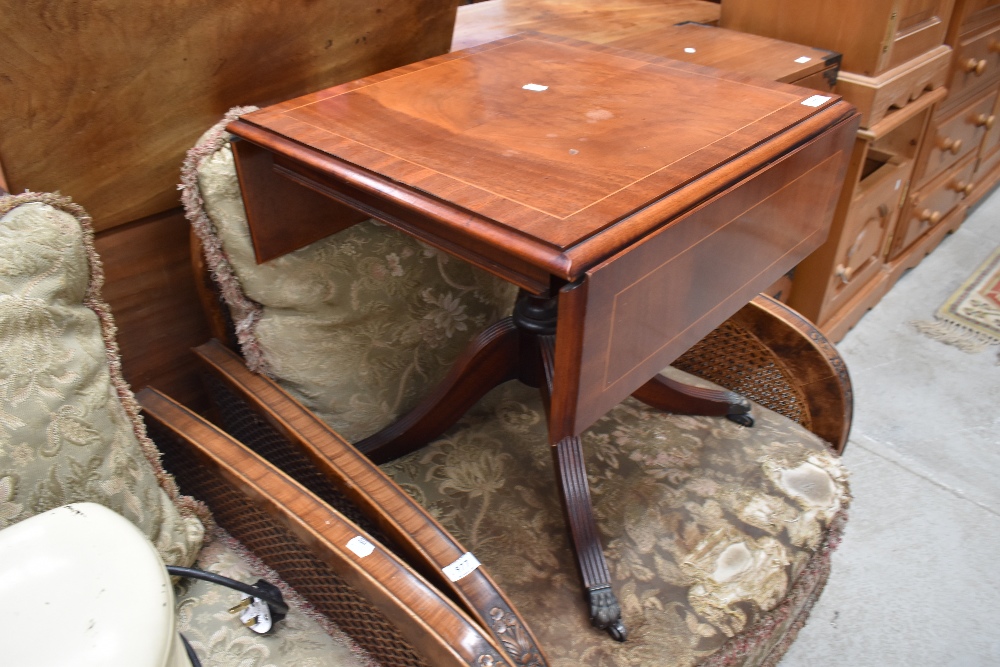 A small tea or similar wine table having metal claw feet