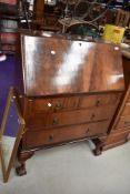 An early 20th Century mahogany bureau on heavy shaped legs with ball and claw feet