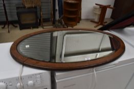 An oak frame oval mirror, width approx. 100cm