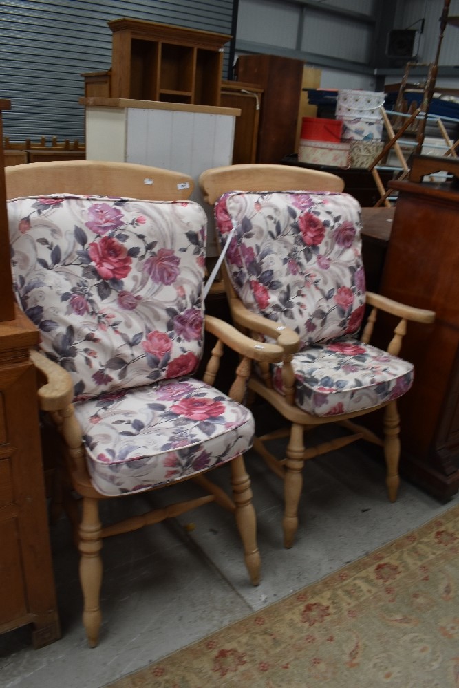 A pair of traditional beech kitchen armchairs, with loose cushions