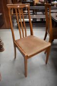 A set of four modern beech wood kitchen chairs with rail back