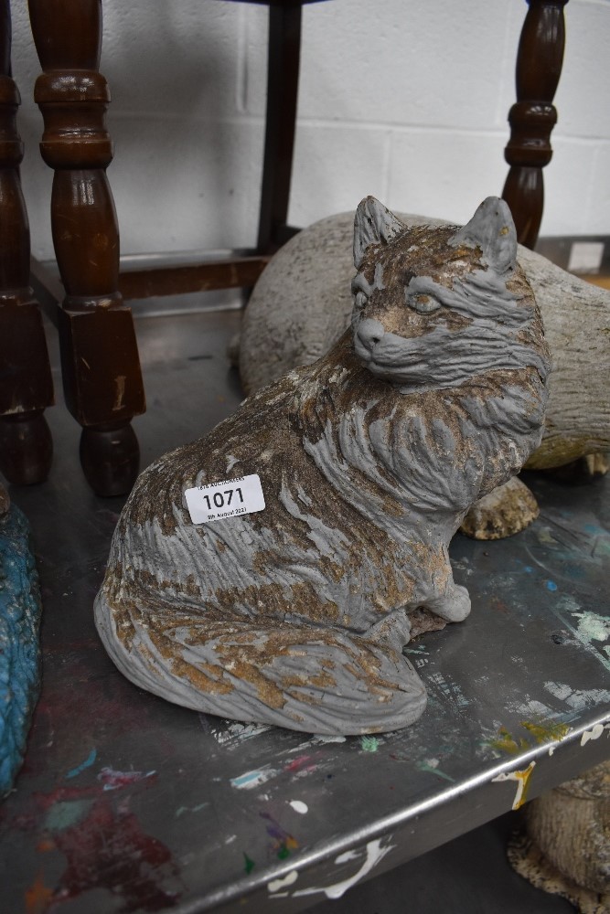 A concrete garden ornament, modelled as a furry cat