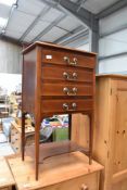 An Edwardian sheet music cabinet with drop fronted drawers, later handles