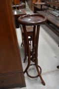 A bentwood plant stand