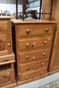 A modern pine chest of drawers, of narrow proportions