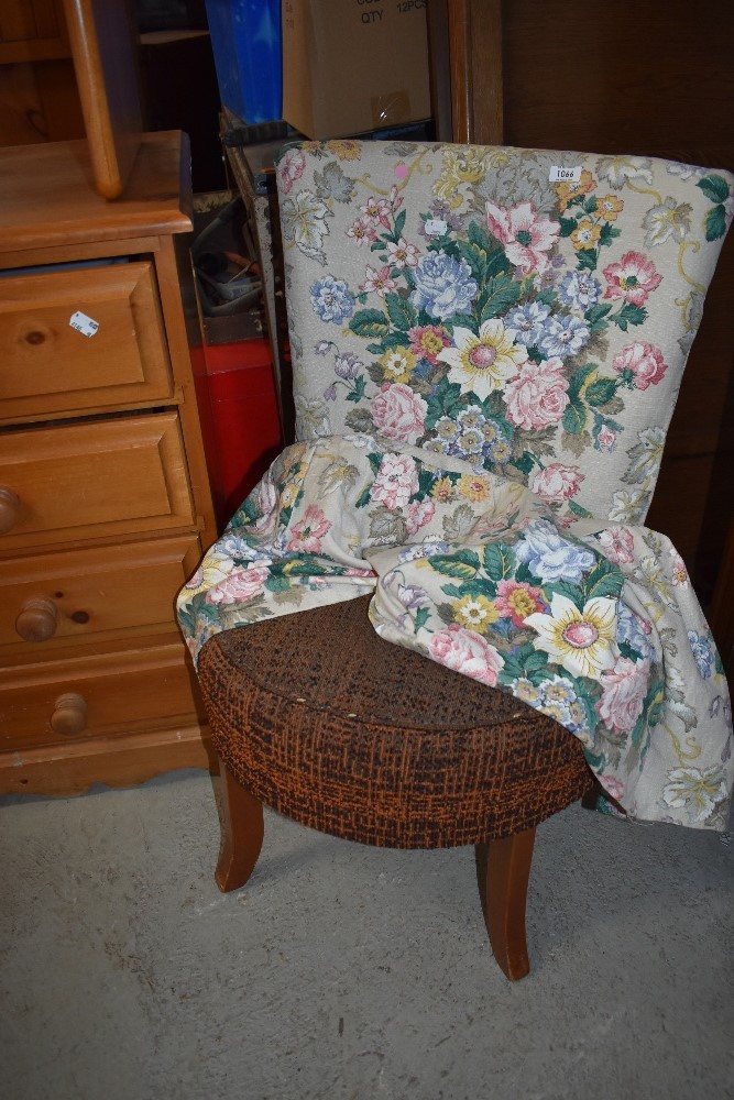 A vintage low seat nursing chair having original upholstery and later loose cover