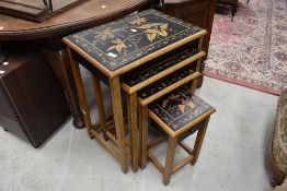 A Chinoiserie nest of our occasional table having ebonised and painted decoration