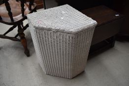 A vintage Lloyd Loom corner linen basket