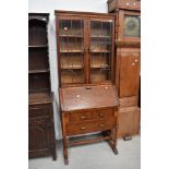 An early to mid 20th Century oak bureau bookcase on barley twist base