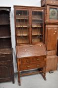 An early to mid 20th Century oak bureau bookcase on barley twist base