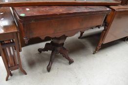 A 19th Century rosewood fold over tea table, having shaped apron and quadruple splay legs, width