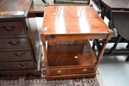 A reproduction yew wood occasional table having brass handled drawer base, width approx. 44cm