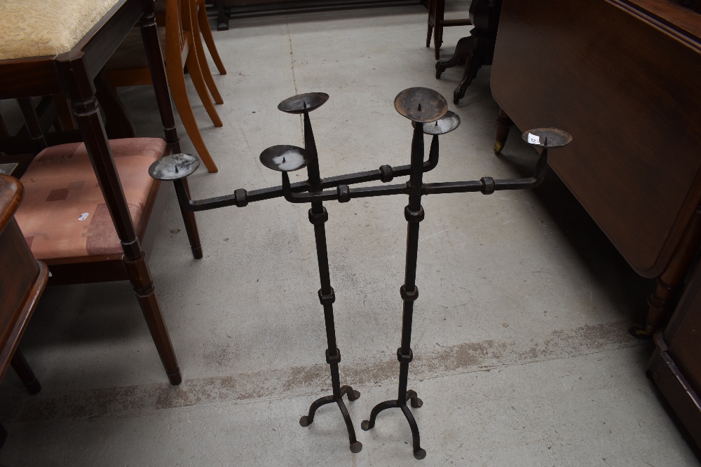 Two wrought iron three branch candle stands