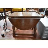 A reproduction oak occasional drop leaf table of traditional form