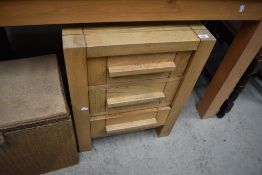 A modern golden oak effect chest of three drawers
