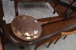 A traditional copper warming pan