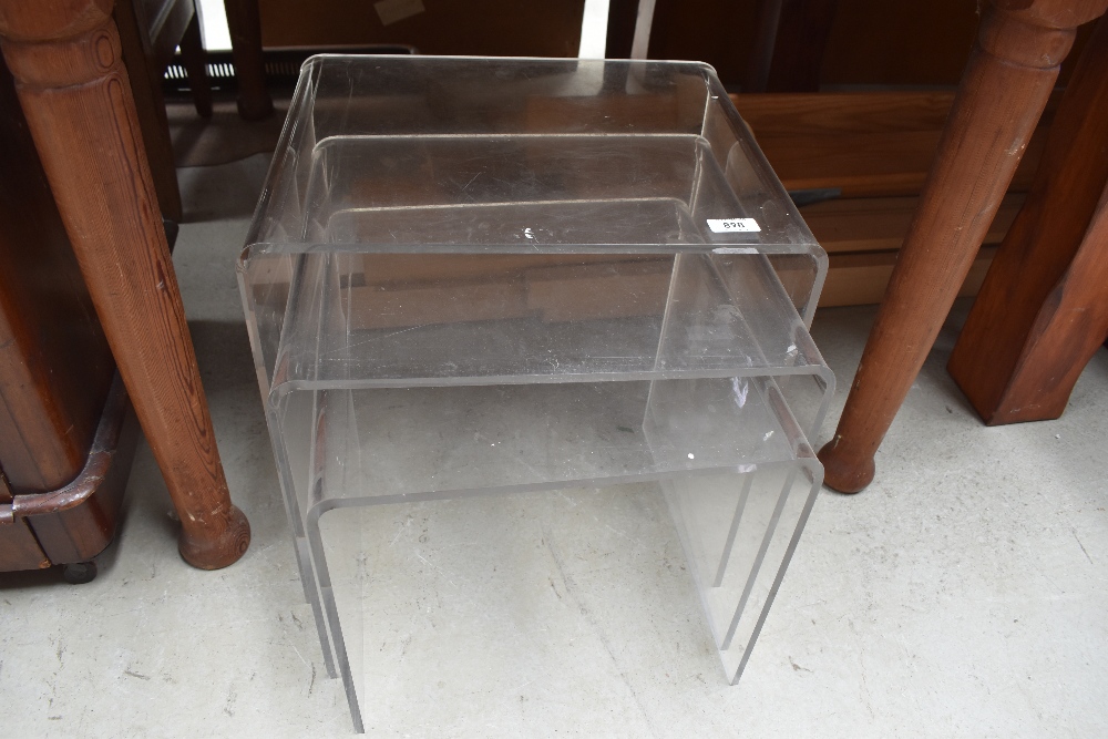 A nest of three modernist clear perspex tables