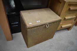 A vintage Lloyd Loom linen/bathroom stool having later cork top