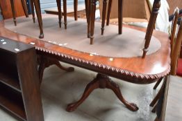 A reproduction banquetting table in the 19th Century style, having gadrooned edge, ball and claw