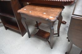 A late Victorian oak occasional table having shaped top and undertier, width approx. 61cm