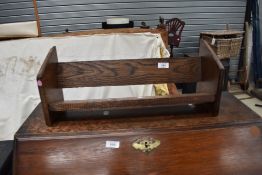 An early 20th Century oak book trough style rack