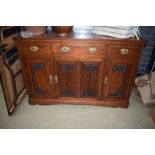 A late Victorian mahogany sideboard having Art Nouveau styling to panelled doors and stylised