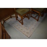 A traditional rug, light colours and quite faded, approx 180 x 120cm