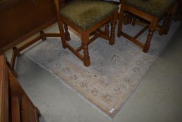 A traditional rug, light colours and quite faded, approx 180 x 120cm