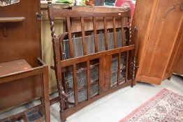 An early 20th Century oak bed having twist frame, side irons and sprung base