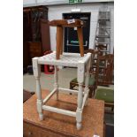 A traditional style milking stool of small proportions and a painted strung stool