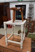 A traditional style milking stool of small proportions and a painted strung stool